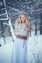 Winter Beauty Woman. Beautiful fashion model girl with snow hairstyle and makeup in the winter forest. Festive makeup and manicure Royalty Free Stock Photo