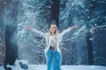 Winter Beauty Woman. Beautiful fashion model girl with snow hairstyle and makeup in the winter forest. Festive makeup and manicure Royalty Free Stock Photo