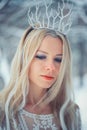 Winter Beauty Woman. Beautiful fashion model girl with snow hairstyle and makeup in the winter forest. Festive makeup and manicure Royalty Free Stock Photo