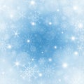 Winter blue background with snowflakes. Bright Christmas frame with snowflakes, sparkles and stars. Winter holiday Royalty Free Stock Photo