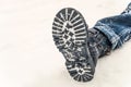 Winter boot on the feet of a boy lying in the snow Royalty Free Stock Photo