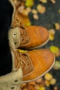 Winter boots with autumn leaves. Close-up. Autumn colors. Concept of fall season