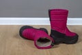 Winter boots snowboots dark pink with black soles on the floor in the room Royalty Free Stock Photo