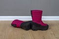 Winter boots snowboots dark pink with black soles on the floor in the room Royalty Free Stock Photo