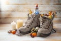 Winter boots, sweets, Christmas decoration and a chocolate Santa against rustic wood, tradition on Nicholas day or in German