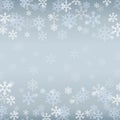 Winter border with white and blue snowflakes on blue blurred soft background. Christmas and New Year holiday wallpaper