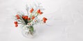 Winter bouquet in glass vase of thuja branches in snow and red rose hips on marble background Royalty Free Stock Photo
