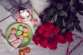 Winter breakfast in bed with red roses and heart of striped lollipop Royalty Free Stock Photo