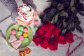 Winter breakfast in bed with red roses and heart of striped lollipop Royalty Free Stock Photo