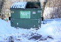 Winter Brothers trash dumpster sits empty in a snowplowed parking lot