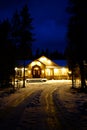 Winter Cabin Glowing Warm at Night Blue Sky