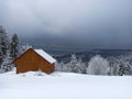 Winter calm mountain landscape with red shed or barn and mount ridge behind polish mountain named turbacz in Poland