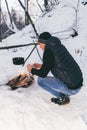 Winter camping, man warm up hands. Boiling water in pot. Wilderness and snow. Witnter time Royalty Free Stock Photo