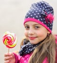 Winter candies concept. Lady with smiling face poses with candy Royalty Free Stock Photo