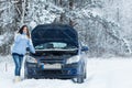 Winter car breakdown - woman call for help. Royalty Free Stock Photo