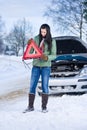 Winter car breakdown - woman warning triangle Royalty Free Stock Photo