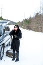 Winter car breakdown - young beautiful woman call for help, road Royalty Free Stock Photo