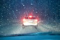 Winter car night driving. snowfall traffic. car silhouette seen through snowy and wet windscreen Royalty Free Stock Photo