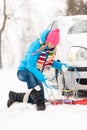 Winter car tire snow chains woman Royalty Free Stock Photo