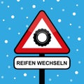 Winter car tire in a triangle road sign with change tires typography Royalty Free Stock Photo