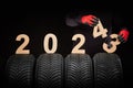car tire services maintance replace wheels and mechanic hands 2024 new year black background Royalty Free Stock Photo