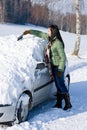 Winter car - woman remove snow from windshield