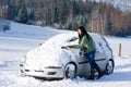 Winter car - woman remove snow from windshield