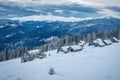 Winter in Carpathian mountains. Abandoned log cabins on the snow Royalty Free Stock Photo