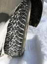 Winter cars tires on snowy road closeup