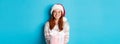 Winter and celebration concept. Beautiful redhead girl in santa hat wishing merry christmas, giving gift and smiling Royalty Free Stock Photo