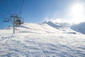 Winter chairlift, ski lift on a sunny day carry skiers Royalty Free Stock Photo