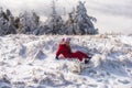 Winter childhood. Adorable little girl having fun on winter day. Cute girl laying in snow