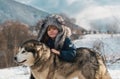 Winter childhood. Child embraced husky dog. Adorable little boy child with husky dog having fun on winter day. Royalty Free Stock Photo