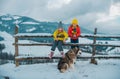 Winter children girl and boy husky dog enjoying winter. Children play outdoors in snow. Outdoor fun for kids Christmas Royalty Free Stock Photo