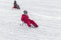 Winter. Children are sledding.