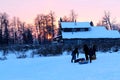 Winter evening people ride a hill on a sled Royalty Free Stock Photo