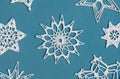 Winter or Christmas background. Crochet snowflakes isolated on light blue. Handmade decorative knitted napkin snowflake Royalty Free Stock Photo