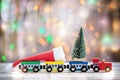 Winter Christmas background Miniature colorful train with fir tree. Holiday greeting card
