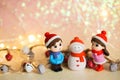 Winter Christmas background with toy figures of a girl and a boy who make a snowman Royalty Free Stock Photo