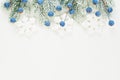 Winter Christmas card composition with blue berries, Xmas tree branch and Snowflakes isolated on white background. Royalty Free Stock Photo