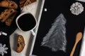 Winter Christmas composition. A cup of coffee on a white table with a black napkin with Italian traditional biscotti cookies and Royalty Free Stock Photo