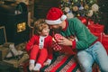 Winter Christmas emotion. Gift emotions. Happy little child son with father dressed in winter clothing think about Santa Royalty Free Stock Photo