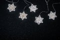 Winter Christmas holiday mockup, white knitted stars, Christmas decorations on dark background with sparkles Royalty Free Stock Photo