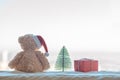 Winter Christmas holidays background with Teddy bear, christmas tree near a window