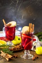 Winter Christmas hot drink with orange, apple and spices. Mulled wine in glass mug with spices. Copy space