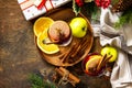 Winter Christmas hot drink with orange, apple and spices. Mulled wine in glass mug with spices on rustic table. Royalty Free Stock Photo