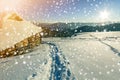 Winter Christmas landscape. Human footprint path in white deep snow at small wooden shepherd hut, spruce forest, woody dark