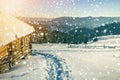 Winter Christmas landscape. Human footprint path in white deep snow at small wooden shepherd hut, spruce forest, woody dark