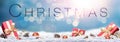 A winter Christmas message banner with red Christmas presents on a festive snow covered landscape Royalty Free Stock Photo