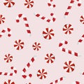 Winter holiday Christmas seamless pattern with candy canes and round swirl candy on beige background Royalty Free Stock Photo